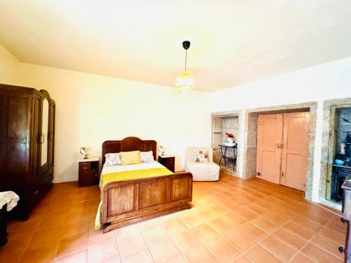 a bedroom with a bed in the middle of a room at Casa dos Capitães Mores - Vila Flor in Vila Flor