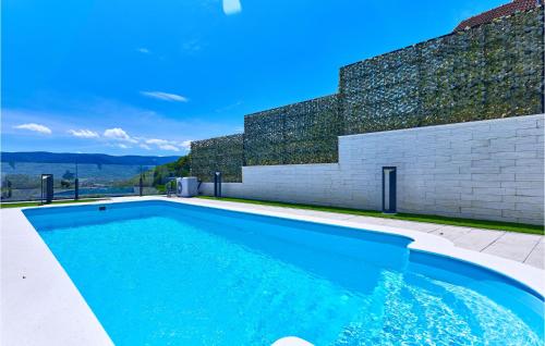 a swimming pool in front of a building at Lovely Home In Donja Stubica in Donja Stubica