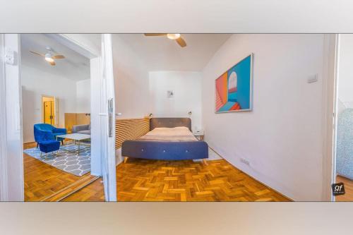 a bedroom with a bed and a table and a chair at King's Little Hideout in Budapest