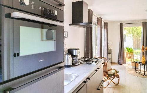 a kitchen with a sink and a stove top oven at 2 Bedroom Cozy Home In Heinkenszand in Heinkensand