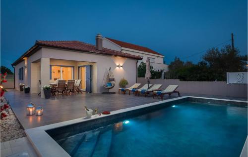 a swimming pool in front of a house at Villa Karla Nin in Nin