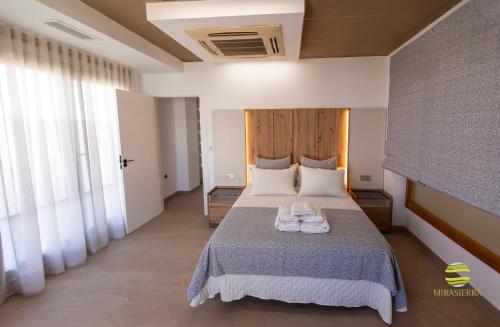 a bedroom with a bed with two towels on it at Mirasierra in Mancha Real