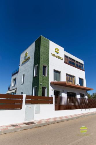 a tall white building with a green at Mirasierra in Mancha Real