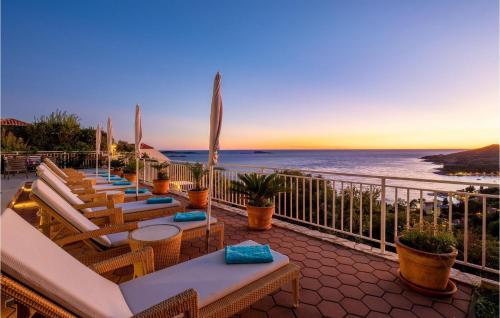a row of chairs and tables on a balcony with the ocean at Villa Libertas in Mlini