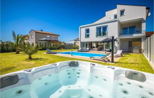 a villa with a swimming pool and a house at Villa Eni in Gedići