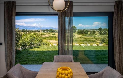 a dining room with a table and a large window at Villa Lux in Donji Zemunik