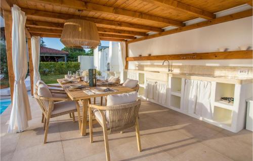 a kitchen and dining room with a table and chairs at Villa San Biagio Star in Poreč