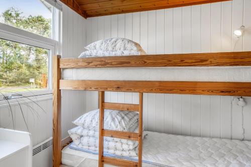 two bunk beds in a small room with a window at Lovely Spa House In Scenic Surroundings in Thyholm