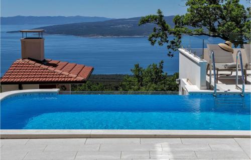 a swimming pool with a view of the water at Villa Prestige in Baška Voda