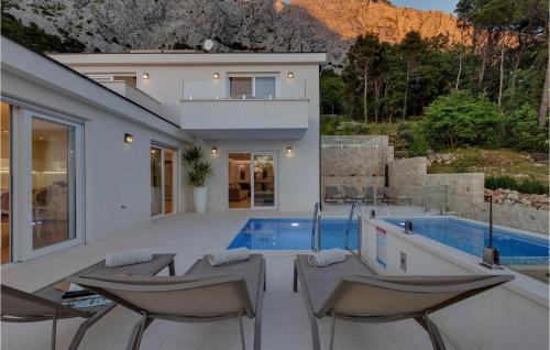 a villa with a swimming pool and a house at Villa Prestige in Baška Voda
