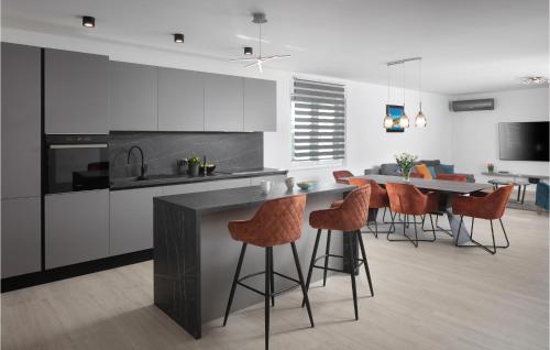 a kitchen with orange bar stools and a counter at Villa Si in Labin