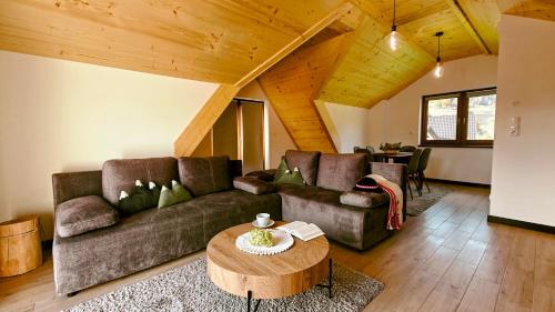 a living room with a couch and a table at Willa Magdalena in Sromowce Niżne