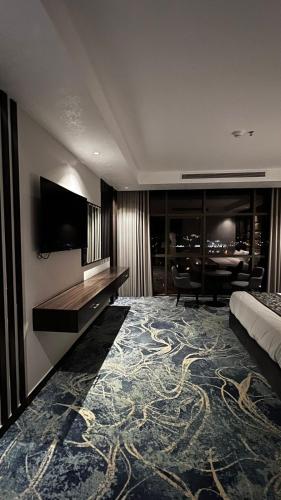 a hotel room with a bed and a flat screen tv at فندق ديماس DEMAS Hotel in Khamis Mushayt