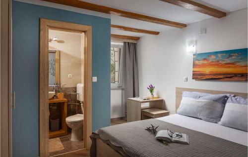a bedroom with a bed and a bathroom at Villa Ancora in Jadranovo