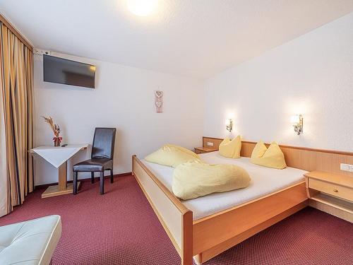 a hotel room with a bed and a chair at Haus Birkenheim in Sölden