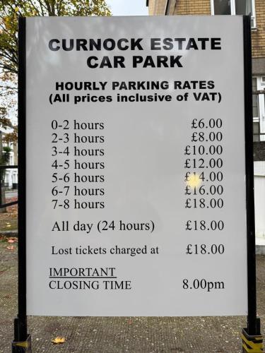 a sign for a car park with a parking rate at Stylish Entire Apartment with Private Garden in Camden, Central London in London