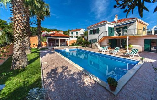 a swimming pool in the backyard of a house at Villa Rasotica in Sumartin