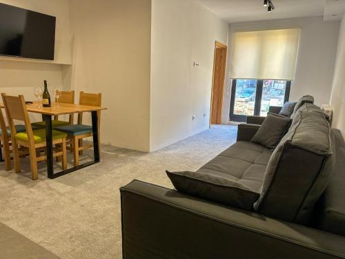 a living room with a couch and a table at Aparthotel Jahorinski Konaci in Jahorina
