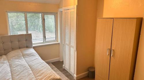 a bedroom with a bed and a window at A Home away from Home in Birmingham