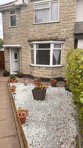 a house with potted plants in front of it at A Home away from Home in Birmingham