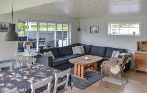 a living room with a couch and a table at Holiday Home Hadsund 09 in Nørre Hurup