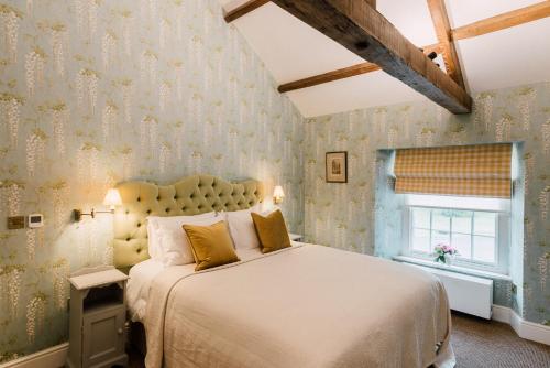 a bedroom with a large bed and a window at The Milbank Arms in Richmond