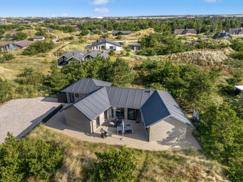 an overhead view of a house with a metal roof at Stylish Activity House From 2018, On A Large Hilly Plot In Søndervig in Ringkøbing