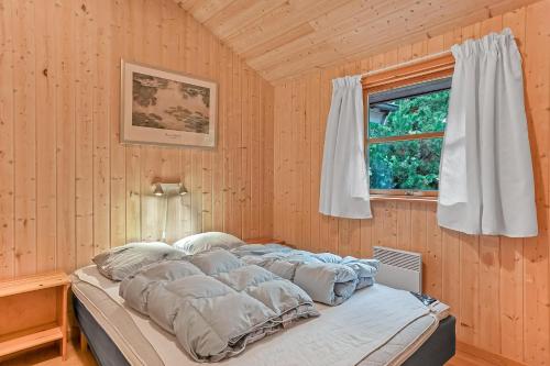 a bed in a room with a window at Cozy And Spacious Holiday Home Near Torup Strand Close To The North Sea in Fjerritslev