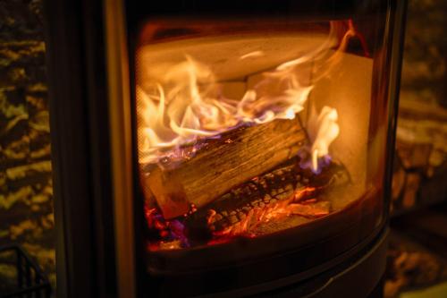a fire inside of an oven with flames in it at Suite Villa Oshino Mt FUJI in Oshino