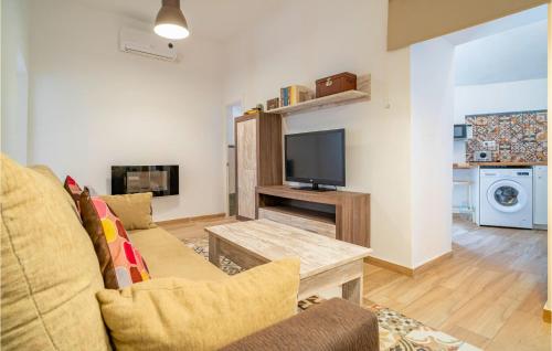 a living room with a couch and a tv at Cozy Apartment In Arcos De La Frontera in Arcos de la Frontera