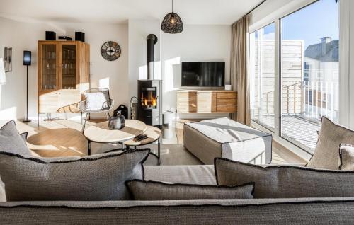 a living room filled with furniture and a large window at Gebirgsresort Winterberg in Winterberg