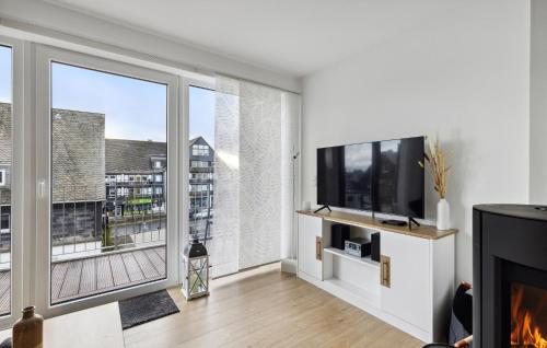 a living room with a fireplace and a large window at Gebirgsresort Winterberg in Winterberg