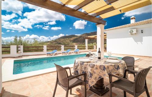 a patio with a table and chairs and a pool at Lovely Home In Periana in Periana