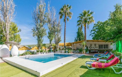 a swimming pool with lounge chairs and a resort at 6 Bedroom Amazing Home In Lucena in Lucena