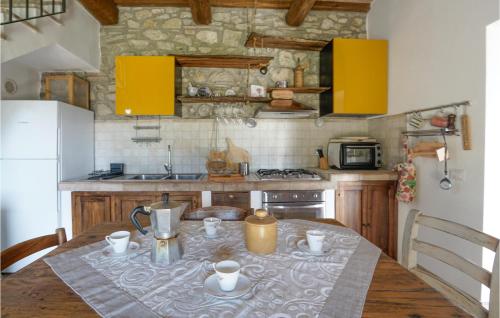a kitchen with a table with a table cloth on it at Pet Friendly Home In Campiglia D'orcia in Campiglia dʼOrcia