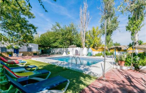 a swimming pool with lawn chairs and a swimming poolvisor at 6 Bedroom Amazing Home In Lucena in Lucena