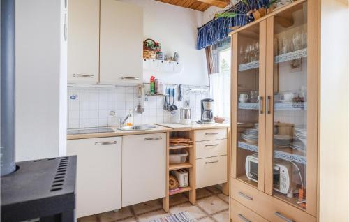 a small kitchen with white cabinets and appliances at Ferienhaus In Rechnitz in Rechnitz