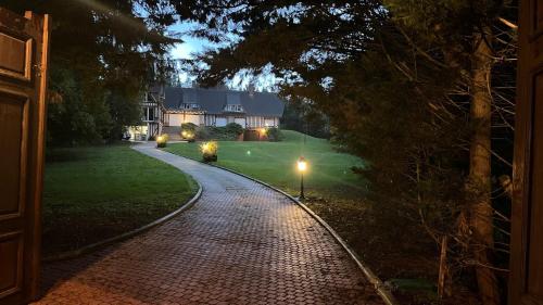 a brick driveway leading to a house at night at Les terrasses de Villevaudé - Disneyland Paris in Villevaudé