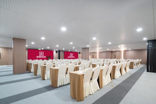 a large room with rows of chairs and a stage at Ruilan Grandyard Hotel in Nanjing