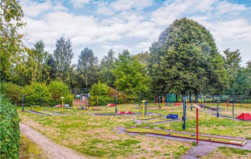 a playground with a bunch of play equipment in a park at Lovely Home In Vlagtwedde With Kitchen in Vlagtwedde