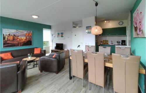 a kitchen and living room with a table and chairs at Lovely Home In Vlagtwedde With Kitchen in Vlagtwedde