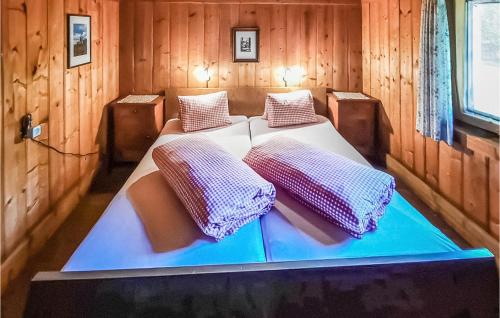 a bedroom with two beds in a wooden room at Ferienhaus In Maria Luggau in Maria Luggau