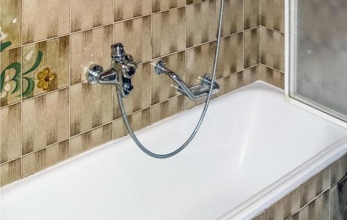 a bathtub with a hose attached to a wall at Ferienhaus In Maria Luggau in Maria Luggau