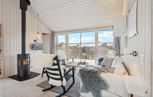 a living room with a couch and a fireplace at 3 Bedroom Cozy Home In Lundby in Lundby