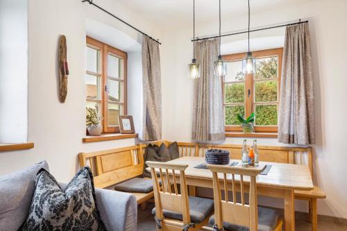 a dining room with a table and a couch at Ferienwohnung z'Dandlberg in Tittmoning