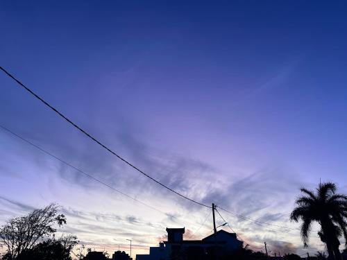 a palm tree in front of a cloudy sky at Teisha House in Souillac