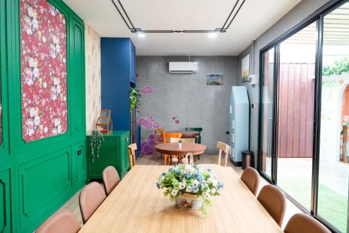 a room with a table with flowers on it at BB Boutique Sathorn in Bangkok