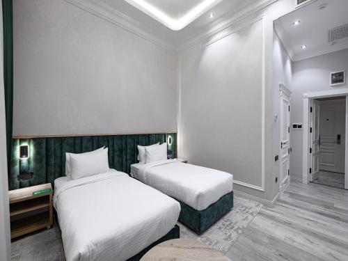 Ένα ή περισσότερα κρεβάτια σε δωμάτιο στο Baden-Baden Hotel Tashkent