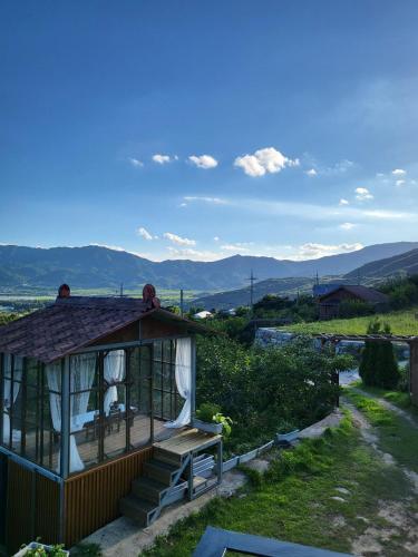 a gazebo with a bench and mountains in the background at Jirigourmoe in Gurye