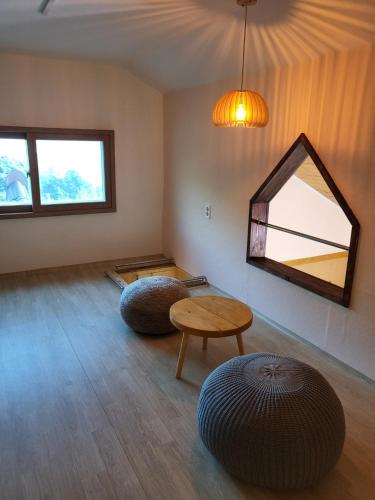 a room with two circular chairs and a table at Jirigourmoe in Gurye